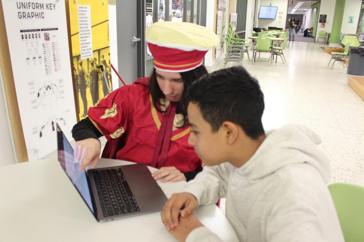 Senior Camilo Vargas gives freshman Paul Heredia a tour of Canvas on October 31.